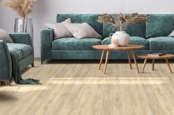 natural wood effect vinyl flooring in a living room with a green sofa